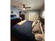 Bedroom featuring large bed, ceiling fan, dresser with tv and large closet at 585 Mourning Dove Cir, Lake Mary, FL 32746