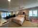 Spacious bedroom with desk, a plush bed, and large bright windows at 585 Mourning Dove Cir, Lake Mary, FL 32746