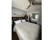 Bright bedroom featuring a queen bed, wood headboard, and mirrored closet doors at 585 Mourning Dove Cir, Lake Mary, FL 32746