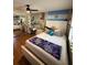 A bedroom featuring laminate flooring, a full bed, a ceiling fan, and a desk setup at 585 Mourning Dove Cir, Lake Mary, FL 32746