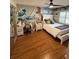 Bedroom featuring laminate flooring, a full bed, a ceiling fan, a desk, and a mirror at 585 Mourning Dove Cir, Lake Mary, FL 32746