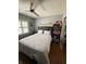 Bedroom featuring a ceiling fan, laminate flooring, bed, large bookshelf and window at 585 Mourning Dove Cir, Lake Mary, FL 32746