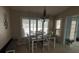 Dining area with a chandelier, plantation shutters, and natural light, great for gatherings at 585 Mourning Dove Cir, Lake Mary, FL 32746