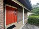 Inviting front entrance with red door and brick exterior under covered porch at 585 Mourning Dove Cir, Lake Mary, FL 32746