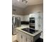 Modern kitchen featuring stainless steel appliances, granite countertops, and a central island at 585 Mourning Dove Cir, Lake Mary, FL 32746