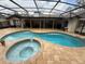 Screened in backyard oasis featuring in ground pool and hot tub at 585 Mourning Dove Cir, Lake Mary, FL 32746