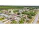 Neighborhood aerial view showcases homes, mature trees, and proximity to a forested area with a nearby body of water at 604 Kangaroo Dr, Poinciana, FL 34759