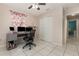 Bright bedroom featuring tile flooring, a ceiling fan, a closet, and a desk setup perfect for a home office at 604 Kangaroo Dr, Poinciana, FL 34759