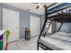 Comfortable bedroom with a bunk bed, white tile floors, and a window providing natural light at 604 Kangaroo Dr, Poinciana, FL 34759