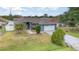 Charming single-story home featuring a manicured lawn and a two-car garage at 604 Kangaroo Dr, Poinciana, FL 34759