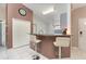 Kitchen area with a countertop bar, pendant lighting, white cabinets and white tile floors at 604 Kangaroo Dr, Poinciana, FL 34759