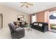 Cozy living room featuring tile flooring, neutral tones, and ample seating at 604 Kangaroo Dr, Poinciana, FL 34759
