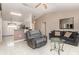 Open-concept living room featuring a view into the kitchen and adjacent dining area at 604 Kangaroo Dr, Poinciana, FL 34759