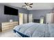 Spacious main bedroom with a large bed, wall-mounted TV, and plenty of closet and dresser storage space at 604 Kangaroo Dr, Poinciana, FL 34759