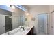 Bright bathroom with double vanity, large mirror, recessed lighting, and a walk-in shower at 6041 Broad Oak Dr, Davenport, FL 33837