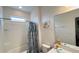 Bright bathroom featuring a tub with shower, decorative seashell shower curtain, and modern vanity at 6041 Broad Oak Dr, Davenport, FL 33837