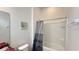 Bright bathroom with a shower-tub combo featuring a tile surround and a shower curtain for privacy at 6041 Broad Oak Dr, Davenport, FL 33837