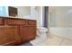 This bathroom features a wooden vanity and a shower and tub combination with a checkered curtain at 6041 Broad Oak Dr, Davenport, FL 33837