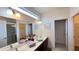Bathroom with a double vanity, shower, and ample storage in a clean, well-lit space at 6041 Broad Oak Dr, Davenport, FL 33837