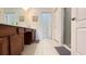 Well-lit bathroom with tile flooring, a vanity with double sinks, and a glass-enclosed shower at 6041 Broad Oak Dr, Davenport, FL 33837
