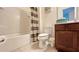 Functional bathroom boasts a shower-tub combo, toilet, vanity, and a clean, well-maintained space at 6041 Broad Oak Dr, Davenport, FL 33837