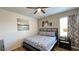 Comfortable bedroom with a queen-sized bed, complemented by stylish decor and ample natural light at 6041 Broad Oak Dr, Davenport, FL 33837