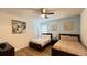 This bedroom features two queen beds, a ceiling fan and light-colored walls at 6041 Broad Oak Dr, Davenport, FL 33837