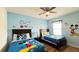 Bright bedroom with two beds, fan, and Mickey Mouse themed decor at 6041 Broad Oak Dr, Davenport, FL 33837