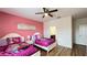 Bright bedroom featuring two beds, themed decor, and a view into the attached bathroom at 6041 Broad Oak Dr, Davenport, FL 33837