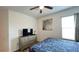 Bedroom featuring queen bed, modern dresser with television, ceiling fan, and decor at 6041 Broad Oak Dr, Davenport, FL 33837