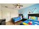 Charming bedroom featuring two beds with Mickey Mouse themed decor and a ceiling fan at 6041 Broad Oak Dr, Davenport, FL 33837