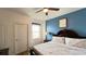 Bedroom featuring a blue accent wall, ceiling fan, and a stylish decor at 6041 Broad Oak Dr, Davenport, FL 33837