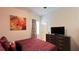 Bedroom featuring modern furniture, a large TV, and a window providing ample natural light at 6041 Broad Oak Dr, Davenport, FL 33837