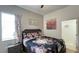 Cozy bedroom featuring a floral-patterned bedspread, matching curtains, and a decorative Gathering-themed sign at 6041 Broad Oak Dr, Davenport, FL 33837