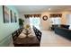 Spacious dining area features a long table set for a large gathering, adjacent to the comfortable living room at 6041 Broad Oak Dr, Davenport, FL 33837