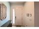 Bright foyer with white door, tile floors, neutral paint and decorative mirror at 6041 Broad Oak Dr, Davenport, FL 33837