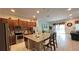 Open-concept kitchen with a granite island and stainless steel appliances that connect to the dining and living areas at 6041 Broad Oak Dr, Davenport, FL 33837