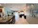 Bright open kitchen with island seating that seamlessly blends the kitchen, dining, and living spaces for easy interaction at 6041 Broad Oak Dr, Davenport, FL 33837
