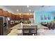 Modern kitchen with dark wood cabinets and granite counters that connects to the dining room at 6041 Broad Oak Dr, Davenport, FL 33837