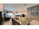 Open-concept kitchen features a granite island overlooking a living room and dining area, perfect for entertaining at 6041 Broad Oak Dr, Davenport, FL 33837
