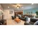 Open-concept living room with kitchen and dining views, features stylish furniture and ample natural light at 6041 Broad Oak Dr, Davenport, FL 33837
