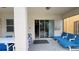 Covered patio features a table, chairs, and lounge furniture, with sliding glass doors leading inside at 6041 Broad Oak Dr, Davenport, FL 33837