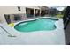 Backyard pool and spa with a safety fence, grill, covered patio, and screened enclosure at 6041 Broad Oak Dr, Davenport, FL 33837