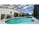 Backyard pool and hot tub with screened enclosure, and outdoor kitchen area with grill at 6041 Broad Oak Dr, Davenport, FL 33837