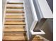 These white and natural wood stairs features white banisters and light hardwood treads at 6041 Broad Oak Dr, Davenport, FL 33837