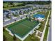 Aerial view of the community including townhomes, common area, and soccer and basketball field at 703 Ocean Course Ave, Davenport, FL 33896