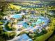 Aerial view of the community's resort-style pool and amenity center surrounded by lush landscaping at 703 Ocean Course Ave, Davenport, FL 33896