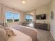 Bright bedroom with plush carpet, balcony access, large window view, and contemporary decor at 703 Ocean Course Ave, Davenport, FL 33896