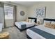 Inviting bedroom featuring two comfortable beds, tasteful decorations, and a bright, airy atmosphere at 703 Ocean Course Ave, Davenport, FL 33896