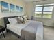 Inviting bedroom with a comfortable bed, neutral tones, and a picturesque view of the golf course at 703 Ocean Course Ave, Davenport, FL 33896